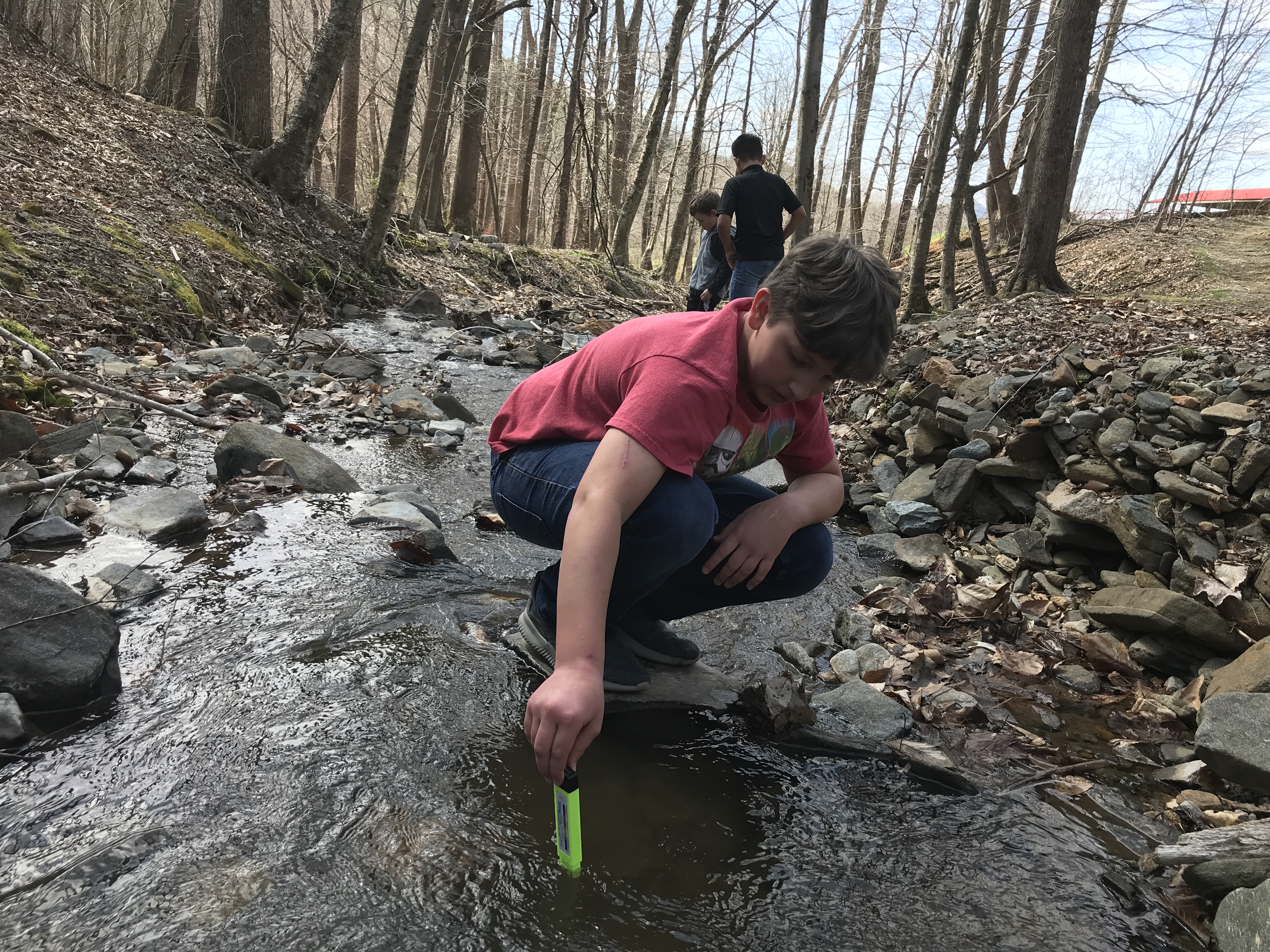 A student tests the stream water during a WOTM program