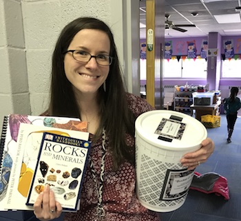 Kristina Shableski from Parkway School 1st Grade with her Bucket O' Rocks and books.